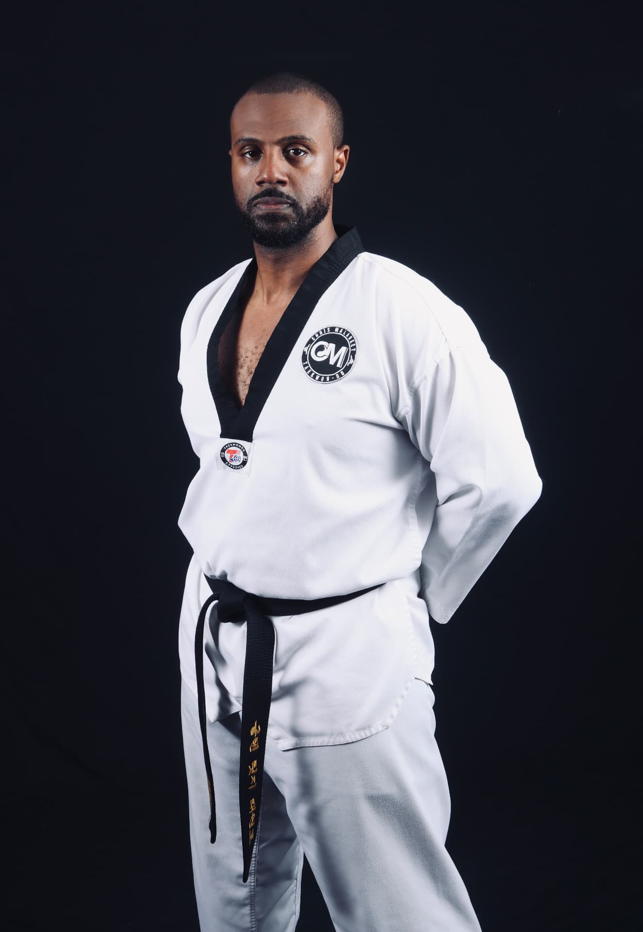 Master Chris Malarkey, founder of Confidence Builder Pro, in a martial arts uniform with black belt